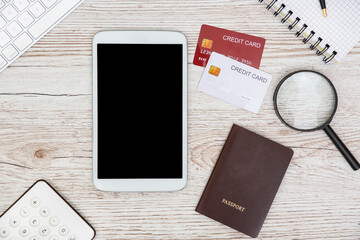 White Tablet With Blank Screen, laptop and accessories and office stuff On Wooden Desk With Stationary Objects , Top View,Travel concept.copy space for text or design