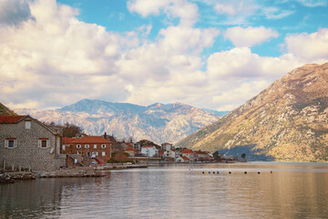 Fototapeta na wymiar Beautiful winter Mediterranean landscape. Small town of Prcanj on coast of Kotor Bay. Montenegro, Adriatic Sea