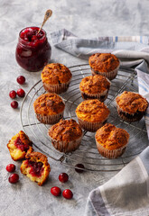 Homemade muffins with cranberry filling, on light background.