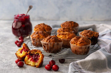 Homemade muffins with cranberry filling, on light background.