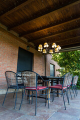 Outdoor dinning set of table and chair in a huge house garden