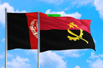 Angola and Afghanistan national flag waving in the wind on a deep blue sky together. High quality fabric. International relations concept.