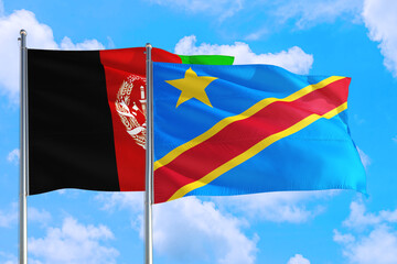Congo and Afghanistan national flag waving in the wind on a deep blue sky together. High quality fabric. International relations concept.
