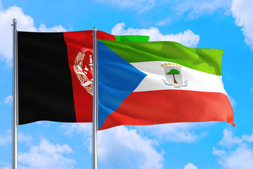 Equatorial Guinea and Afghanistan national flag waving in the wind on a deep blue sky together. High quality fabric. International relations concept.