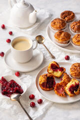 Homemade muffins with cranberry filling, on light background.