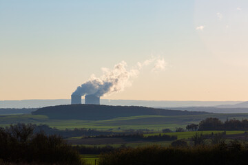 Countryside with nuclear plant cooling towers and vapor