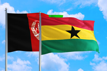 Ghana and Afghanistan national flag waving in the wind on a deep blue sky together. High quality fabric. International relations concept.