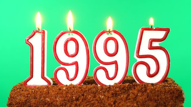 Cake with the number 1995 lighted candle. Last century date. Chroma key. Green Screen. Isolated