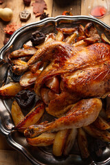 Close-up top view of round dish with baked turkey and potato. Festive dinner. Thanksgiving concept. Traditional recipe.