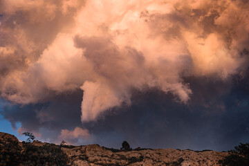 Fototapeta premium Storm Clouds Illuminated by Sunset Light