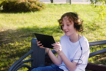 teen in the Park with a tablet
