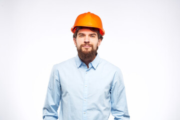 Engineer in orange coloring construction professional safety industry light background