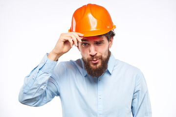 Man in an orange helmet shirt Engineering work construction cropped view