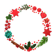 Christmas wreath with holly & loose berries, winter greenery & bauble decorations on white background. Abstract composition for the xmas holiday season. Flat lay, top view, copy space.
