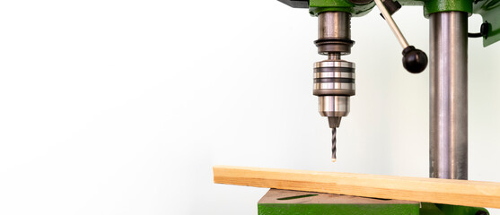  a  steel  bench drill machine in the factory isolated, working process