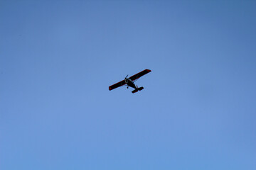 Fototapeta na wymiar Ein kleines Propeller Flugzeug am blauen Himmel.