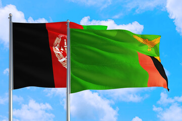 Zambia and Afghanistan national flag waving in the wind on a deep blue sky together. High quality fabric. International relations concept.