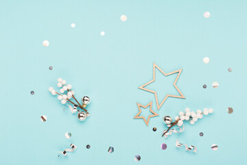 Christmas decorations, snowflakes, glitter stars on pastel blue background. Flat lay, top view.