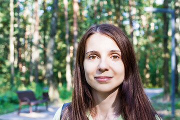 Portrait of girl the park at autumn enjoying nature. Female with positive emotions. Face of beautiful attractive young woman.