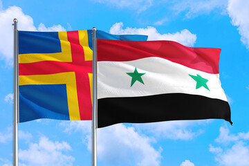 Syria and Aland Islands national flag waving in the windy deep blue sky. Diplomacy and international relations concept.