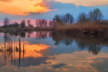 Beautiful sunset near small fishing pond