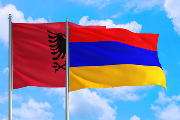 Armenia and Albania national flag waving in the windy deep blue sky. Diplomacy and international relations concept.