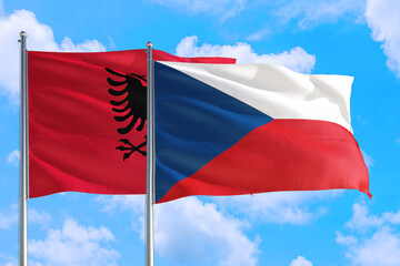 Fototapeta na wymiar Czech Republic and Albania national flag waving in the windy deep blue sky. Diplomacy and international relations concept.