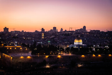 
panorama of jerusalem with a mosque dome on the rock in the light of the setting sun