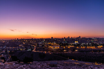 panorama of jerusalem from 
Jewish cemetery on the Olive Hill with a mosque dome on the rock in the light of the setting sun