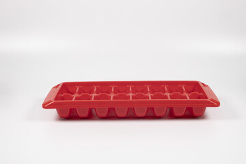 Closeup shot of a red ice cube tray on white background