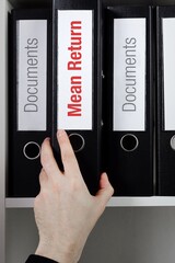 Mean Return. File Folder is taking by a hand from office shelf. Red Text is on the label of the...