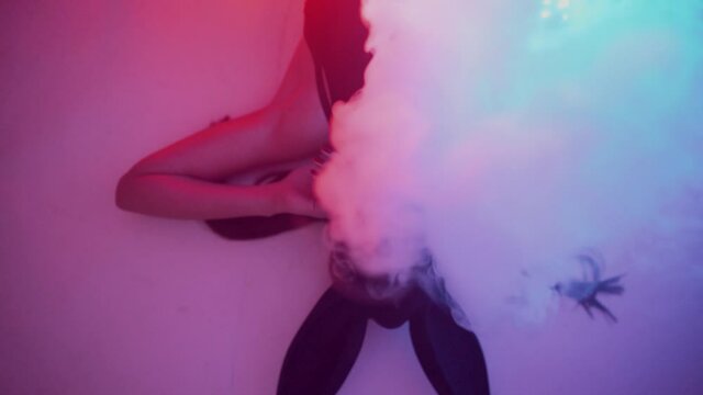 Sexy woman in hare mask posing and gesturing at camera