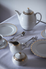 Set of porcelain tableware,  prepared on a table in a modern restaurant.