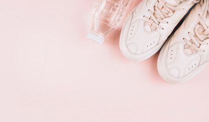 Healthy lifestyle. Sports equipment on a pink background. Sports concept. The apartment was lying. Top view with copy space. Banner.