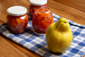 ripe quince and jars with quince jam