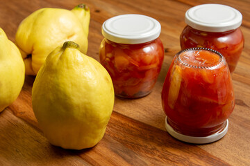 ripe quince and jars with quince jam