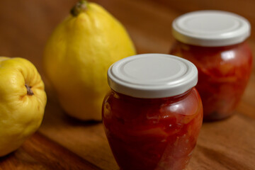 ripe quince and jars with quince jam