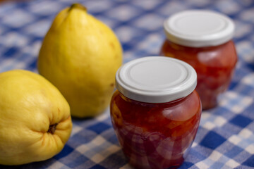 ripe quince and jars with quince jam