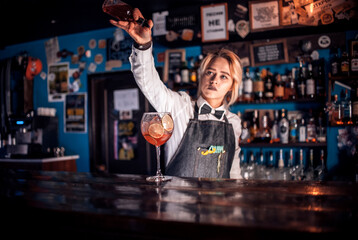Charismatic girl tapster demonstrates his professional skills in the pub