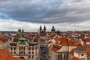 Naklejka na ściany i meble Aerial view of Prague old town and cityscape with church of Our Lady before Tyn on the Old Town Square on a cloudy day from top of Clementinum, Prague, Czech Republic