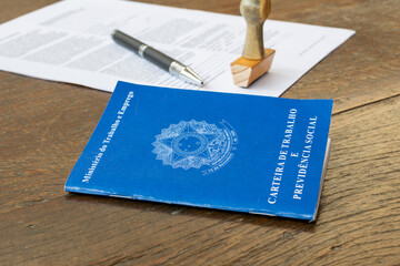 Brazilian Work Card with stamp, pen and paper on the rustic table. Employment contract concept....