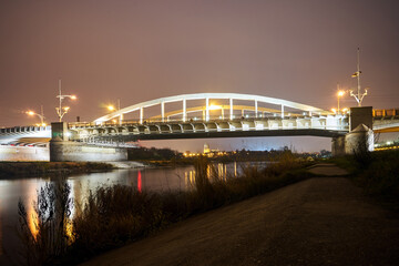 Fototapeta premium Steel structure of road bridge over the Warta river at nigh