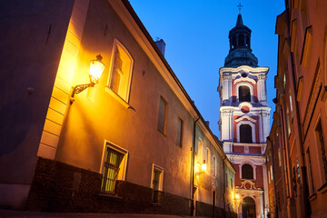 narrow street and belfry of the baroque historic church