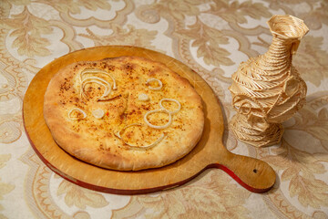 Freshly cooked delicious closed pie with hot cheese inside