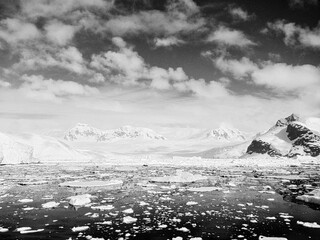 Black and White View of Antarctic Bay Backed by Snowy Mountains