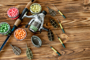 Accessories for carp fishing and fishing baits on wooden planks with copy space