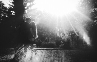 Beautiful young couple walking in the park. A romantic walk of man and woman, black and white photo. photo with noise. soft focus