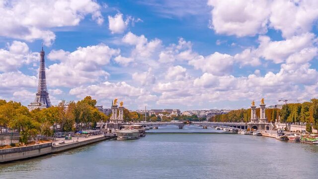 A timelapse of the Eiffel Tower along the river Seine with flyboats passing by with motion blur.Sunny but cloudy autumn day with golden yellow leaves,paris city riverside bay view bridge panorama