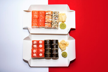 Different kind of rolls and sushi isolated over white and red background