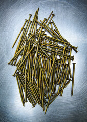 Overhead view of nails on a metal surface